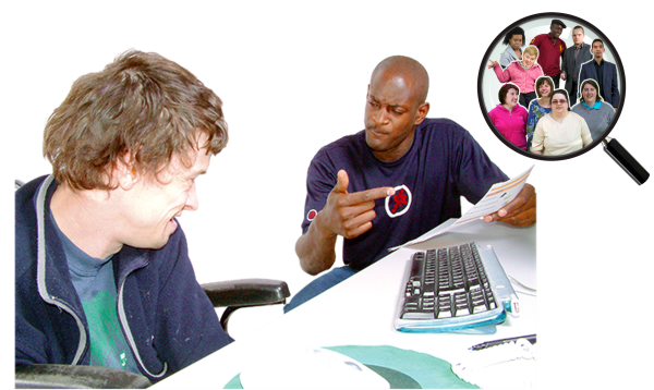 A man sitting at a computer helping another man who is sitting next to him to find someone.