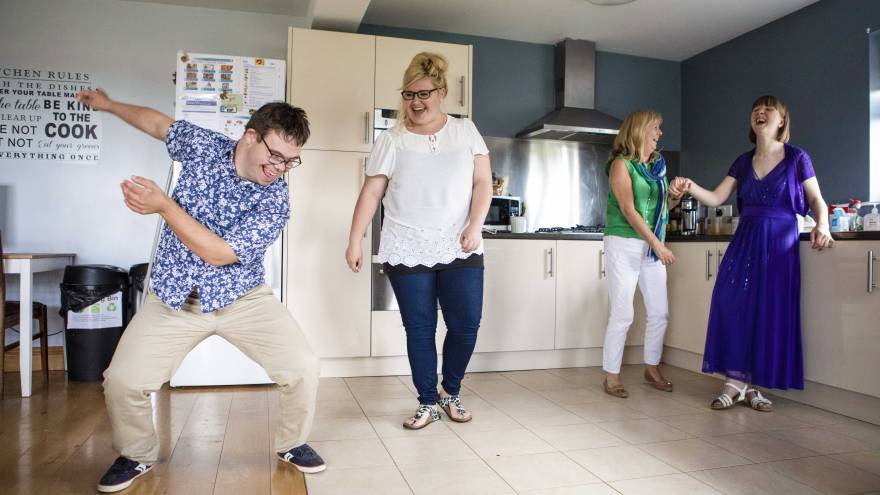 Group of people dancing in a kitchen