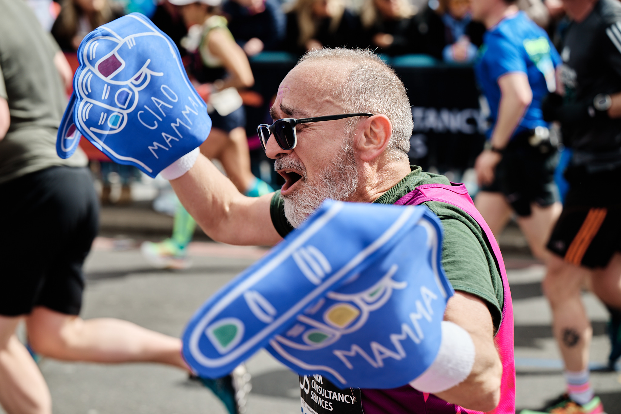 Runner cheering in middle of the crowd