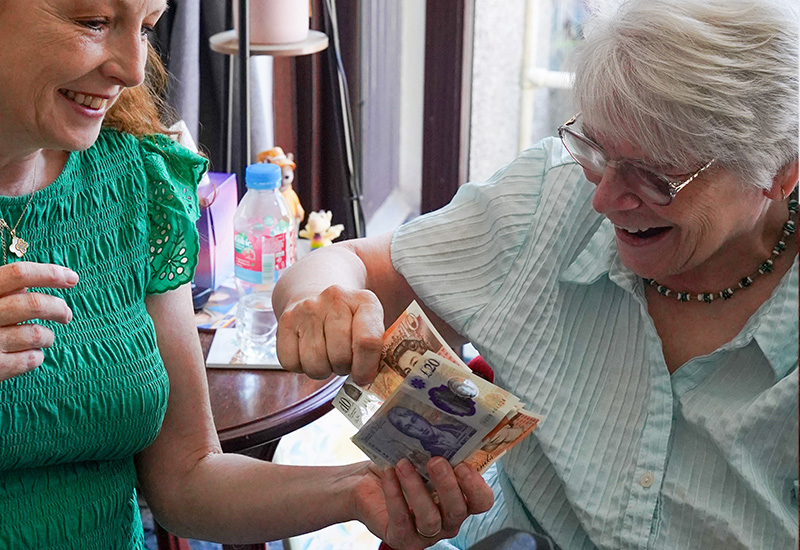 Two women counting money