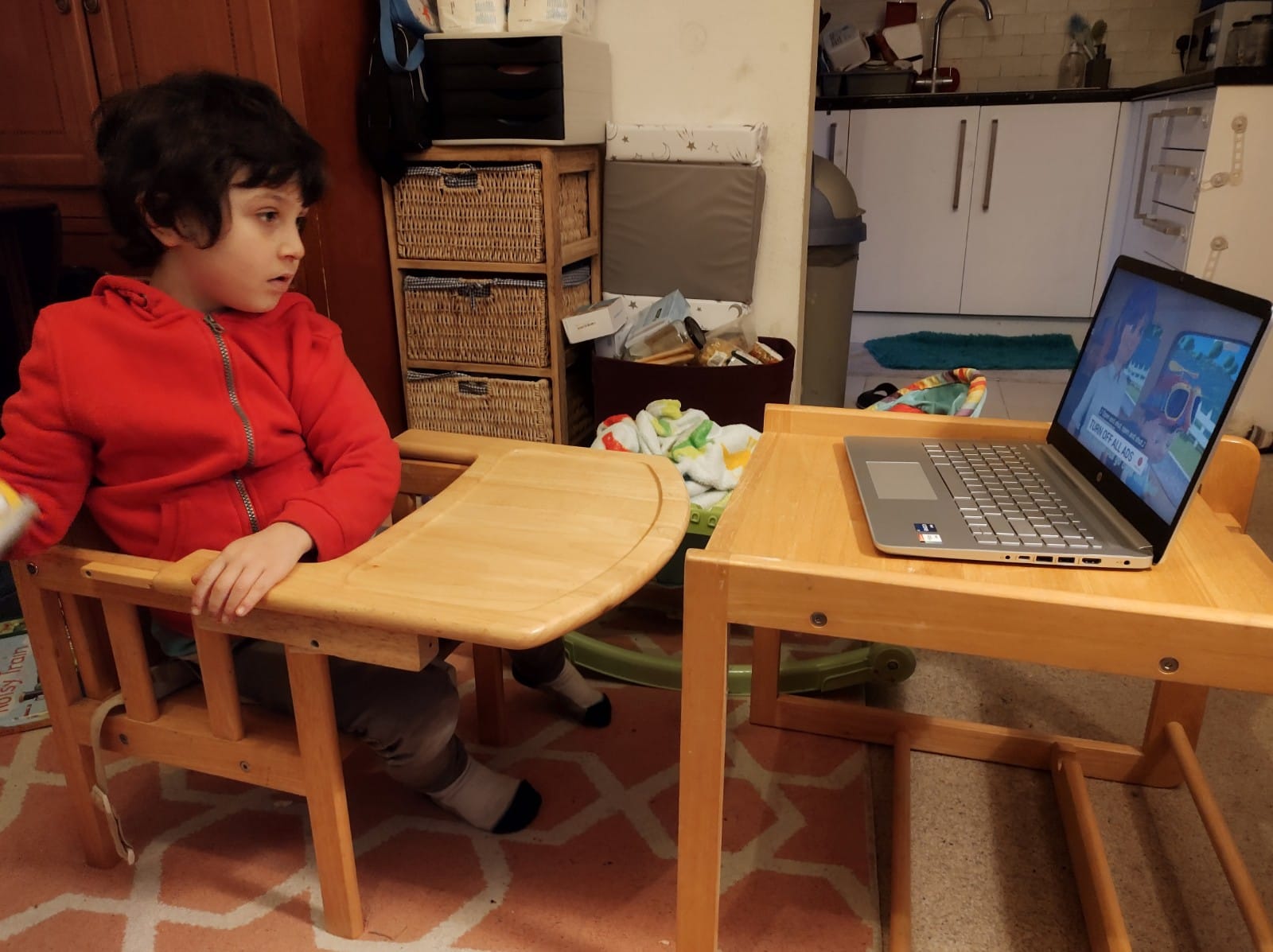 A boy looks at a laptop