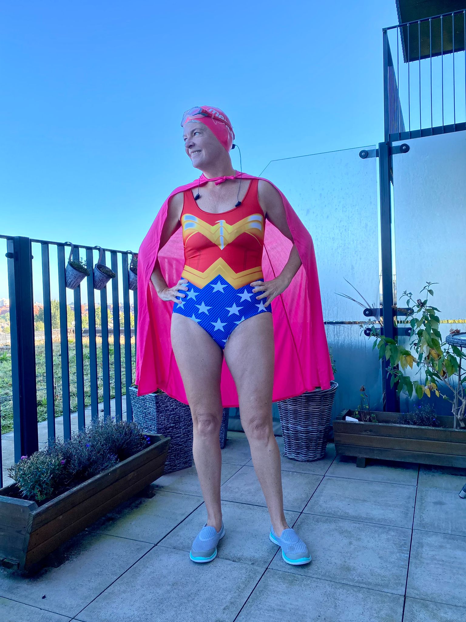 Edel Harris in a superhero swimsuit and cape