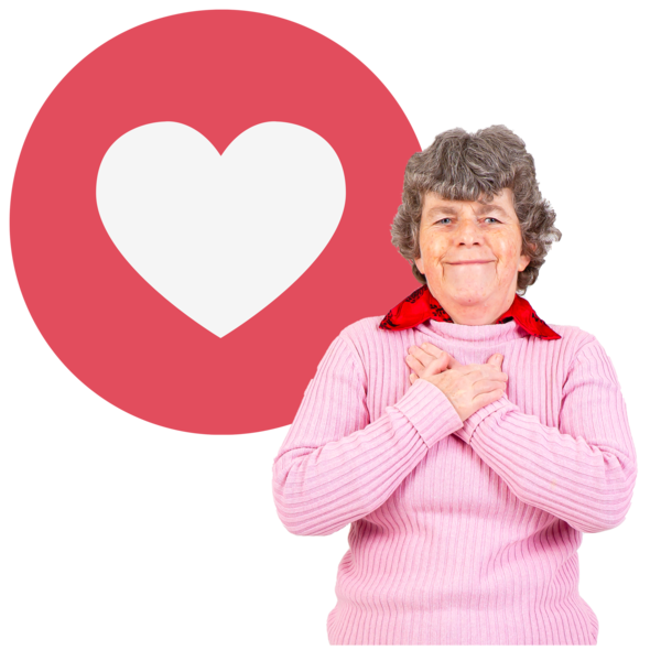 A woman next to a love heart sign with her hands over her heart