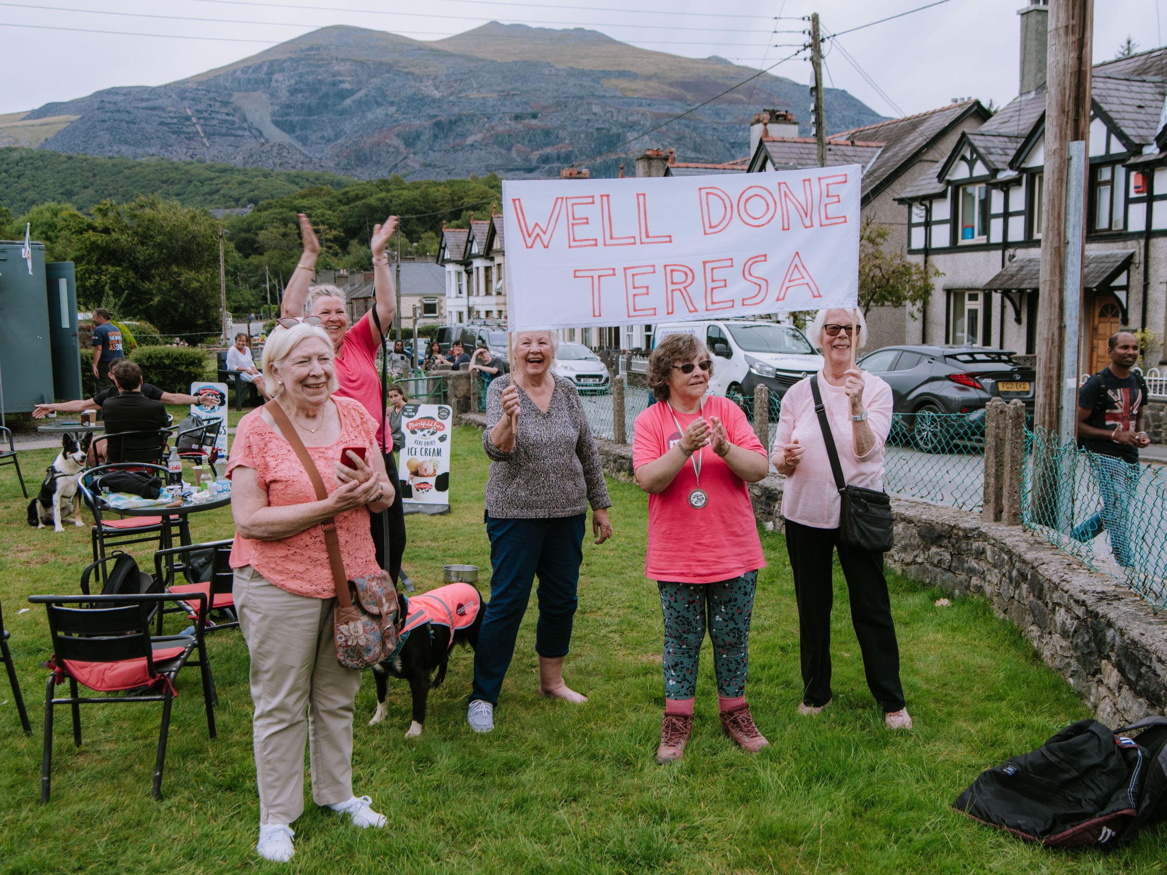 Volunteers cheering people on in a pretty country village green