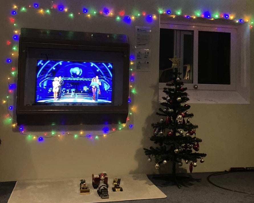 A room decorated with Christmas lights and a Christmas tree