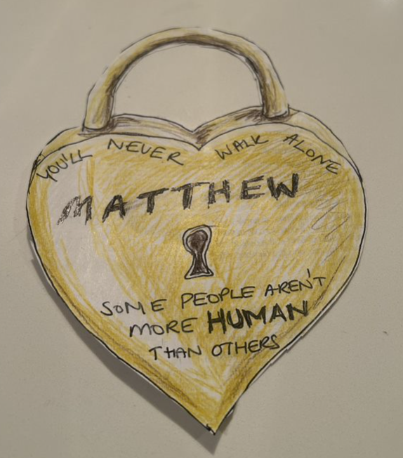 Hand drawn padlock in the shape of a heart, with text that reads "You'll never walk alone Matthew. Some people aren't more human than others."