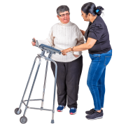 A lady gets support to walk from her friend, using a walking frame. 