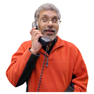 A man in a red jumper talking on the phone