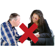 A cross through a picture of a social worker talking to a man with a learning disability