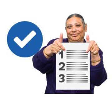 A woman holding up a list with her thumbs up and a tick symbol next to her
