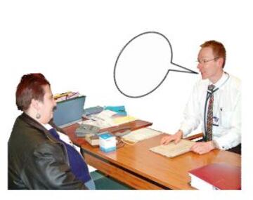 A doctor talking to a patient at a desk