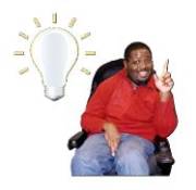 A man in a wheel chair with one hand raised sitting next to a light bulb