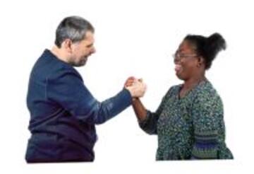 A couple shaking hands smiling at each other