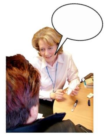 A doctor talking to another woman at a desk