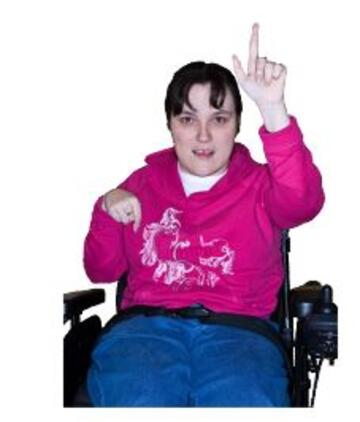 A man in a wheelchair with his hand raised to ask a question