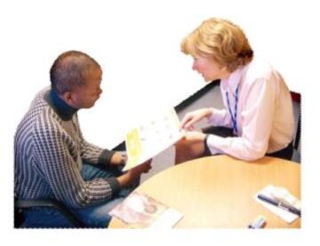 A doctor showing a patient an easy read guide