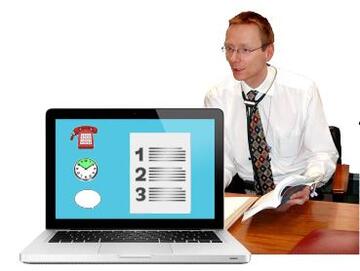A doctor at a computer with an easy read message on the screen