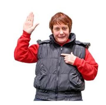 A woman with her hand raised to ask a question