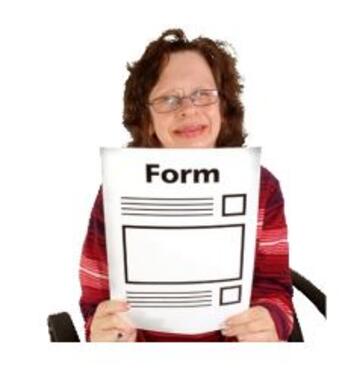 A woman holding up a form