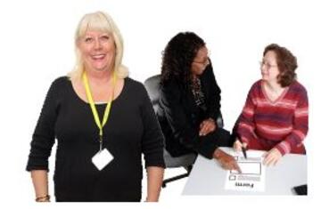 A social worker and support worker helping a woman at a desk
