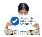 A woman holding up an easy read document of the Accessible Information Standard
