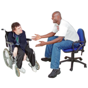A seated man who is talking to another man who is in a wheelchair