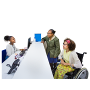 Two women at a doctors reception desk (one in a wheel chair) They are both talking to the receptionist behind the desk.
