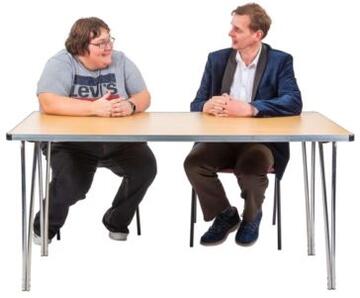 Two men talking at a table