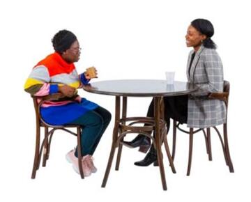 Two women talking over a coffee at a table