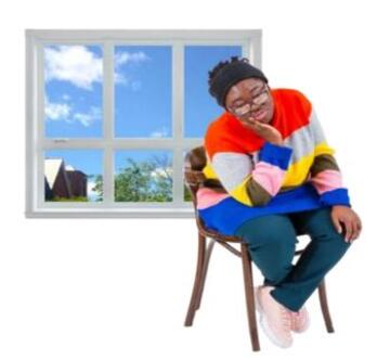 A woman thinking on a chair in front of a window