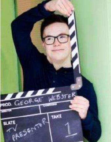 A man with downs syndrome holding up a clapper board