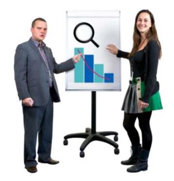 A man and a woman standing next to a clipboard and pointing to a graph on it