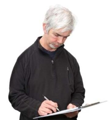 A man writing on a clipboard