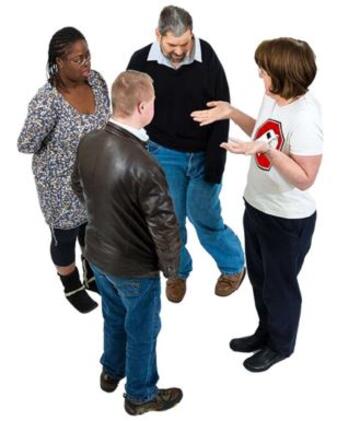 Four people standing in a circle talking
