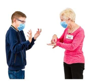 Two people taking in British Sign Language