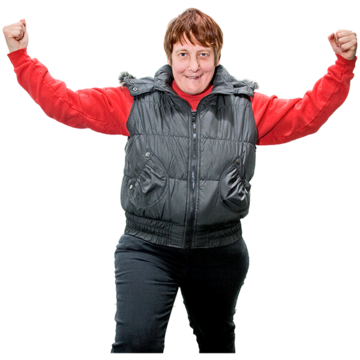 A woman in a red top with a grey jacket raising both her arms to show how strong she is