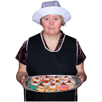 A woman with a cooks uniform and hat serving a tray of cakes