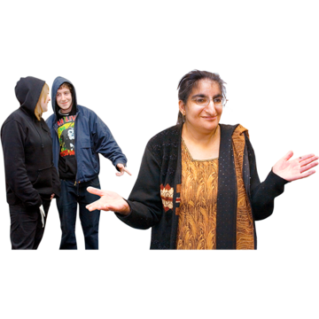 A woman walking away from two bullies wearing hoodies.