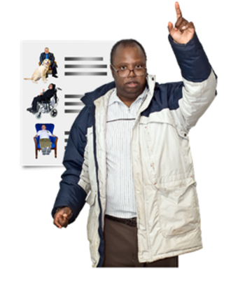 A man wearing a coat has his hand up in the air.  Behind him is a piece of paper with images of people and writing next to them.