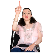 A lady in a wheelchair with her right hand raised and her index finger pointing up