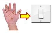 The virus on a hand next to a light switch