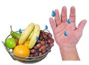 Drops of the virus on a hand and on a basket of fruit