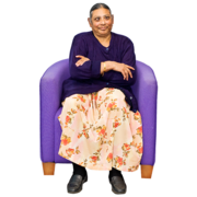 A woman waiting in a chair with her arms folded