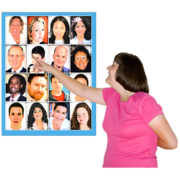 A woman pointing to a member of staff on a chart which is full of pictures of all the members of staff