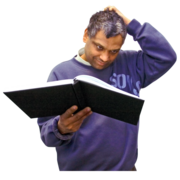 a man reading an instruction manual and scratching his head in confusion