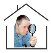 An outline of a building with the photograph of a man looking through a magnifying glass inside it.