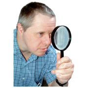 A man looking through a magnifying glass