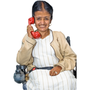 A woman in a wheelchair talking on a red phone