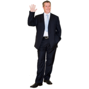 A man in a suit smiling and waving