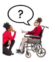 A woman in a wheelchair asking a question to someone who is kneeling down listening to them